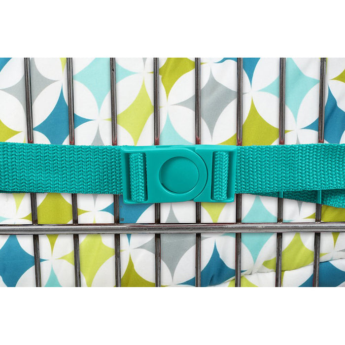 A close-up of a teal strap with a round button clasp on the Nuby 2-in-1 Universal Size Shopping Cart & High Chair Cover, secured around a metal frame and patterned with geometric shapes in white, green, blue, and gray.