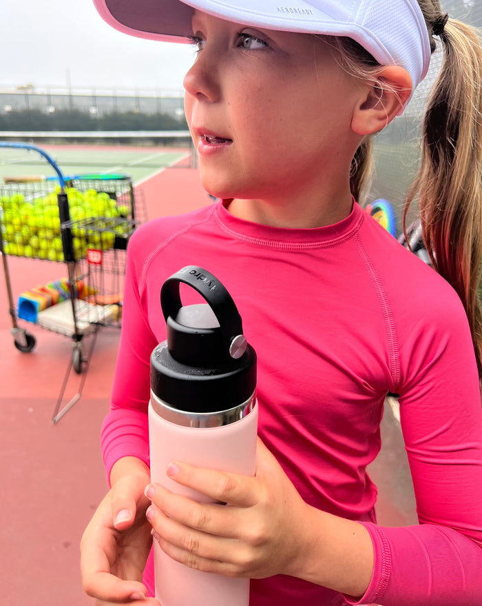 Girl wearing watermelon top at tennis court. (Style 1005K) - BloqUV