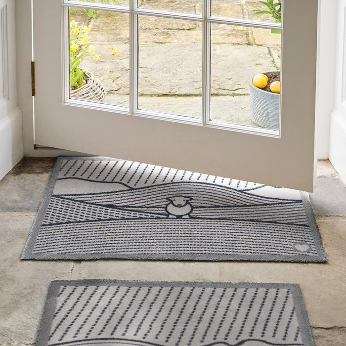 Herdy Lines Doormat- A cotton doormat featuring a Herdy in a field.