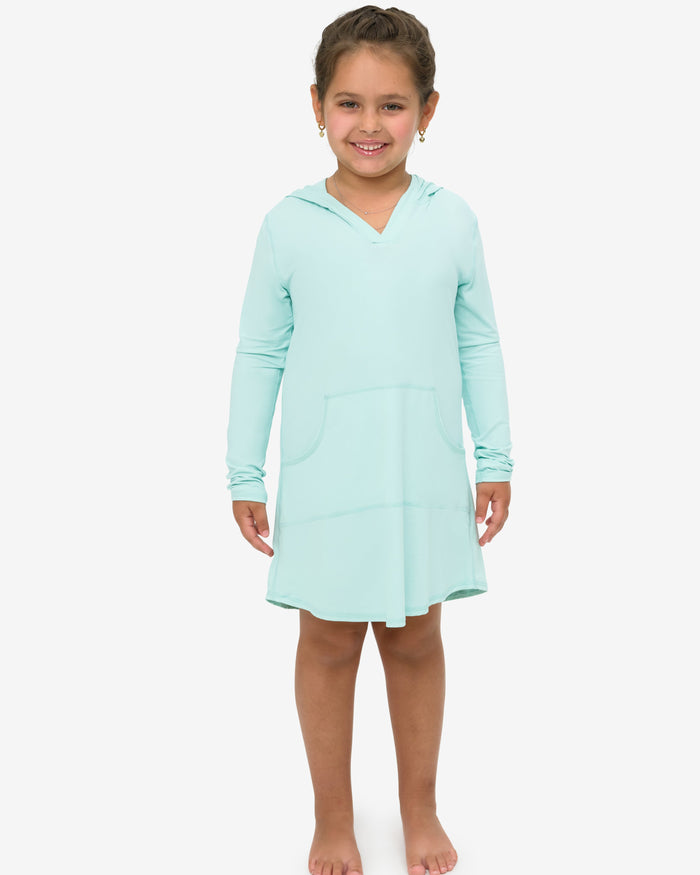 Young girl wearing a light blue nightshirt on a white background