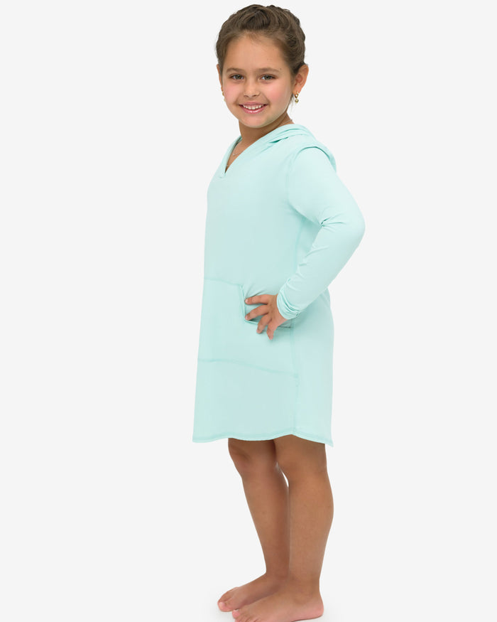Young girl wearing a light blue nightshirt on a white background