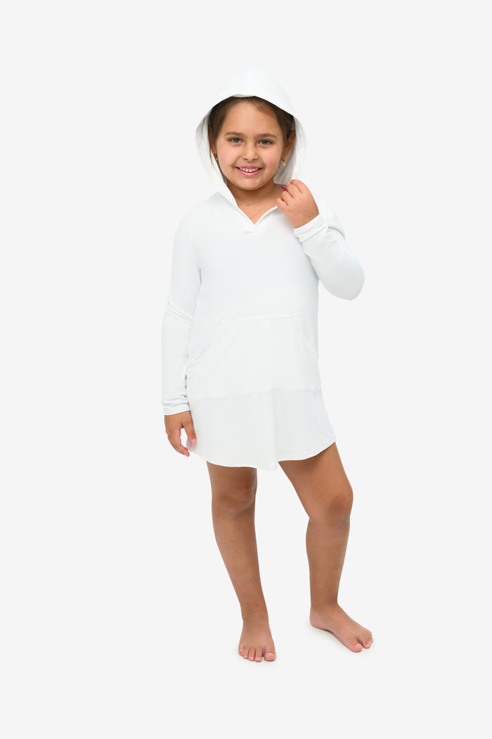 Person wearing a white hooded dress on a plain background