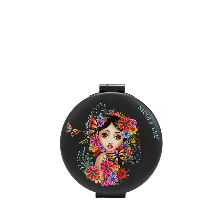 FRONT OF THE MIRROR HAS A BLACK BACKGROUND , IN THE MIDDLE IS A GIRL FACE WITH BLACK HAIR LOOKING AT YOU, SURROUNDED BY COLORFULL FLOWERS AND MONARCH BUTTERFLIES, WITH A SMALL NICOLE LEE LOG ON THE EDGE..