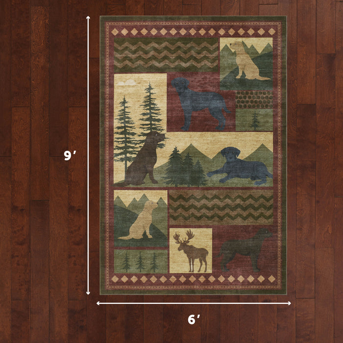 Patchwork area rug with wildlife silhouettes including bears, moose, and dogs among trees and geometric patterns in green, bu