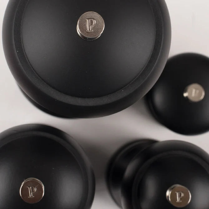 Black pepper grinders with a visible brand logo on a light background