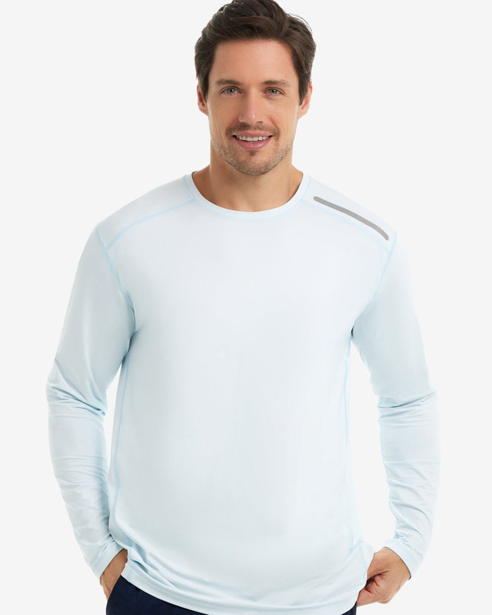 Man wearing a light blue long-sleeve shirt on a white background