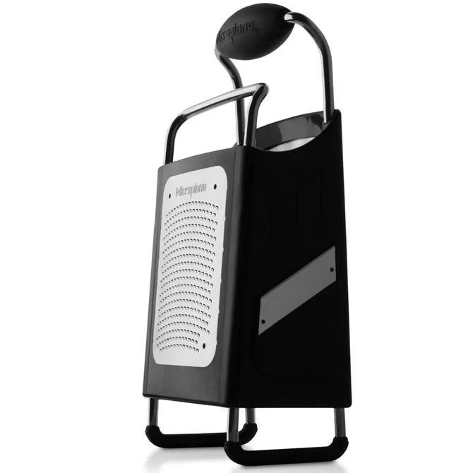 Black and silver box grater on a white background