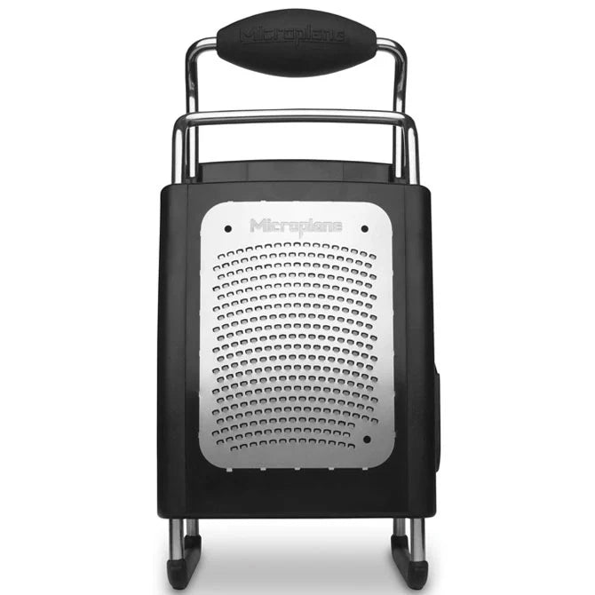 Black box grater with metal handle on a white background