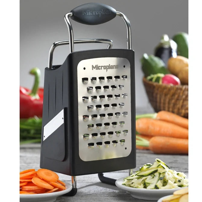 Box grater with vegetables on a table
