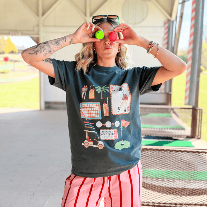 Person wearing a graphic t-shirt with colorful designs outdoors
