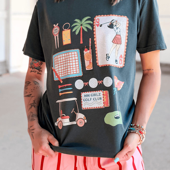 Person wearing a black t-shirt with colorful graphics and text.