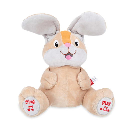 The Plush Motion Toy is a beige and white bunny with large floppy ears and a smiling face. “Sing” and “Play” with symbols are stitched in red on its feet for interactive peek-a-boo play.