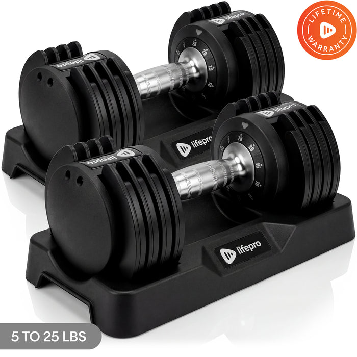Pair of PowerUp Plus adjustable dumbbells in their storage tray, dials set to different weights, with a 5 to 25 lb label and Lifetime Warranty badge.