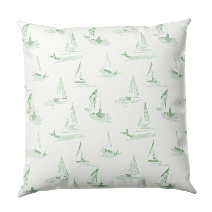 Pillow with green sailboat pattern on a white background