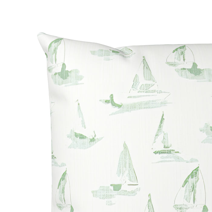 Pillow with green sailboat pattern on a white background
