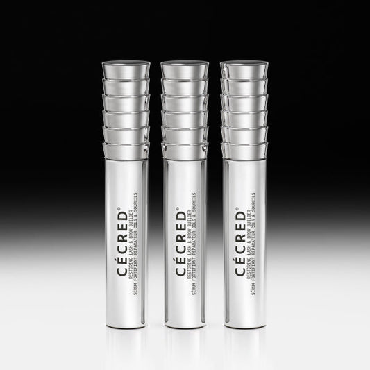 Three tubes of Cécred Restoring Lash & Brow Builder serum standing together on a gradient background