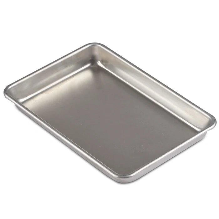 Stainless steel baking tray on a white background