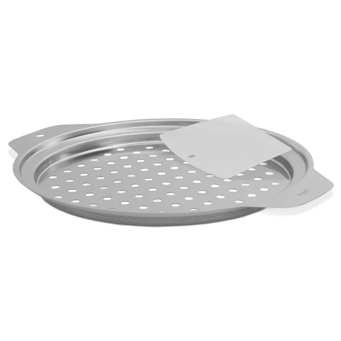 A stainless steel spaetzle top with a scraper, featuring a perforated grater-style lid and a flanged design for easy grip, accompanied by a dough scraper.