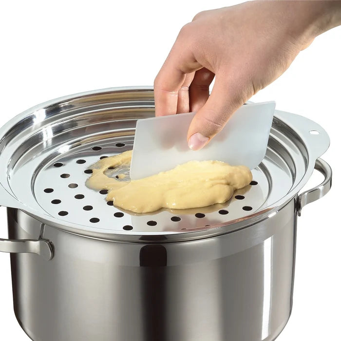 Hand using a bowl scrapper to handle dough on a metal steamer basket.