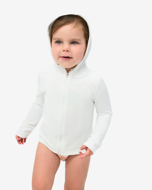 A toddler wearing a long sleeve full zip hoodie top in white on a white background
