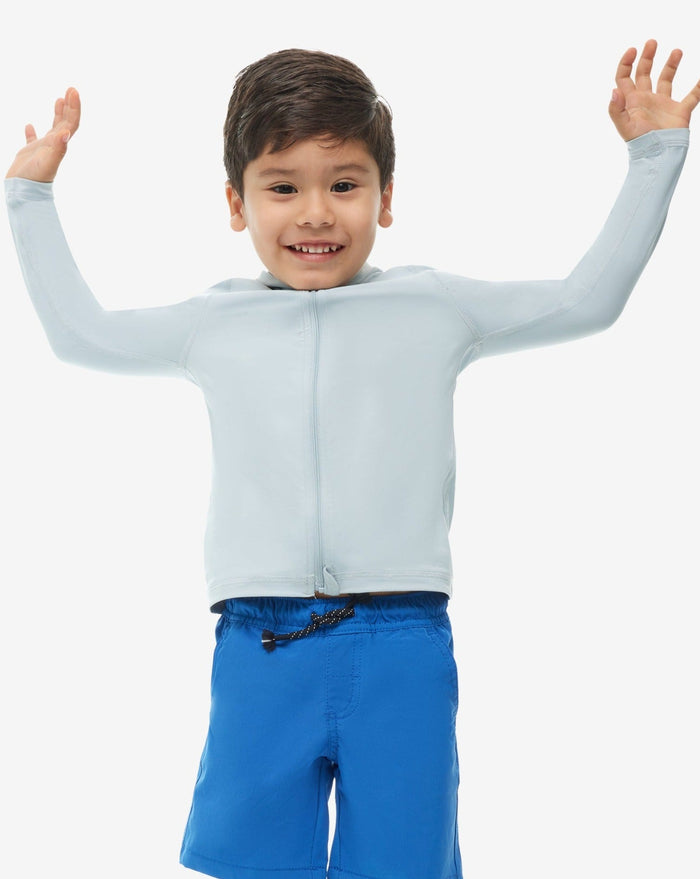 A toddler wearing a long sleeve full zip hoodie top in blue on a white background