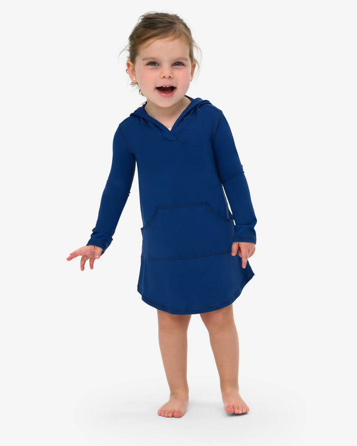A toddler in a blue hoodie dress with long sleeves and a hood, standing against a white background.