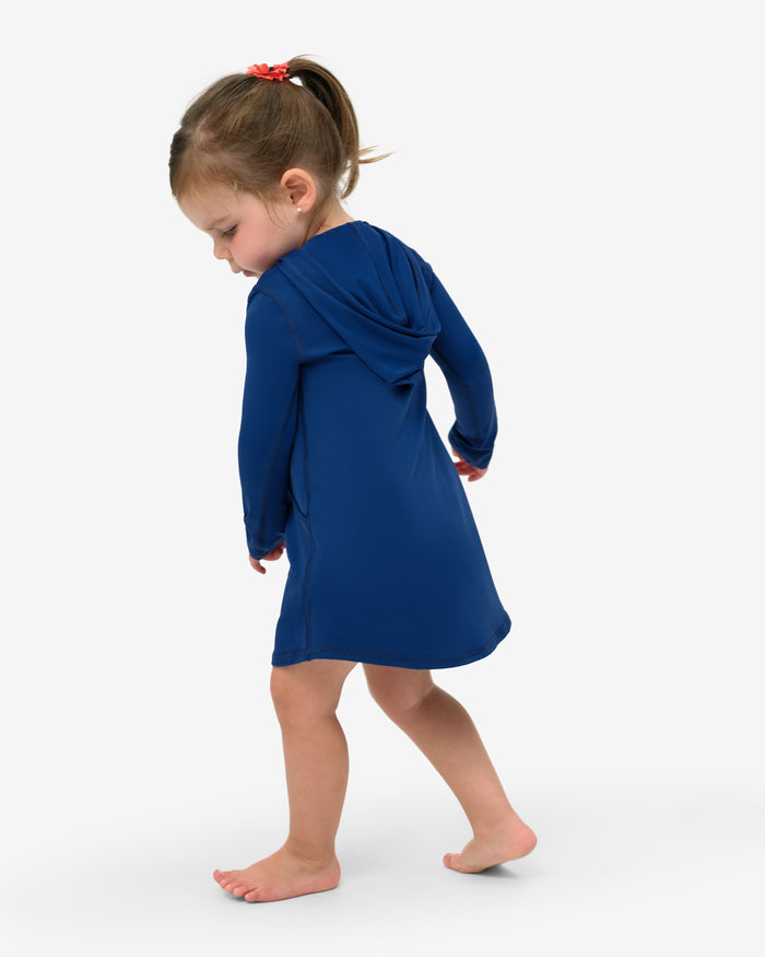 A toddler in a blue hoodie dress with long sleeves and a hood, standing against a white background.