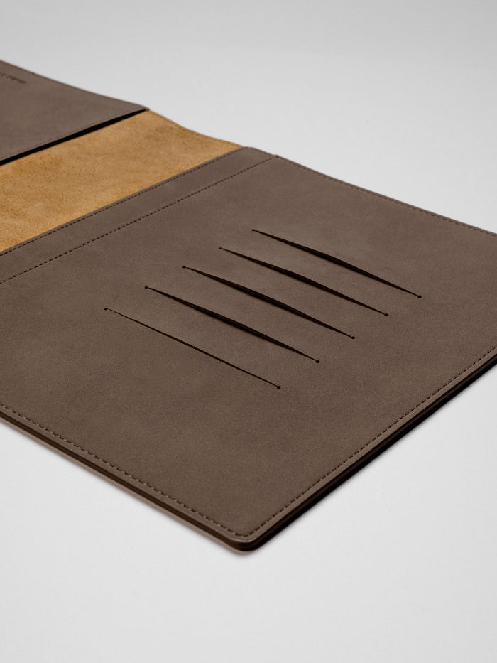 Espresso folio displayed on a neutral background. Emphasis is placed on its credit card slots.