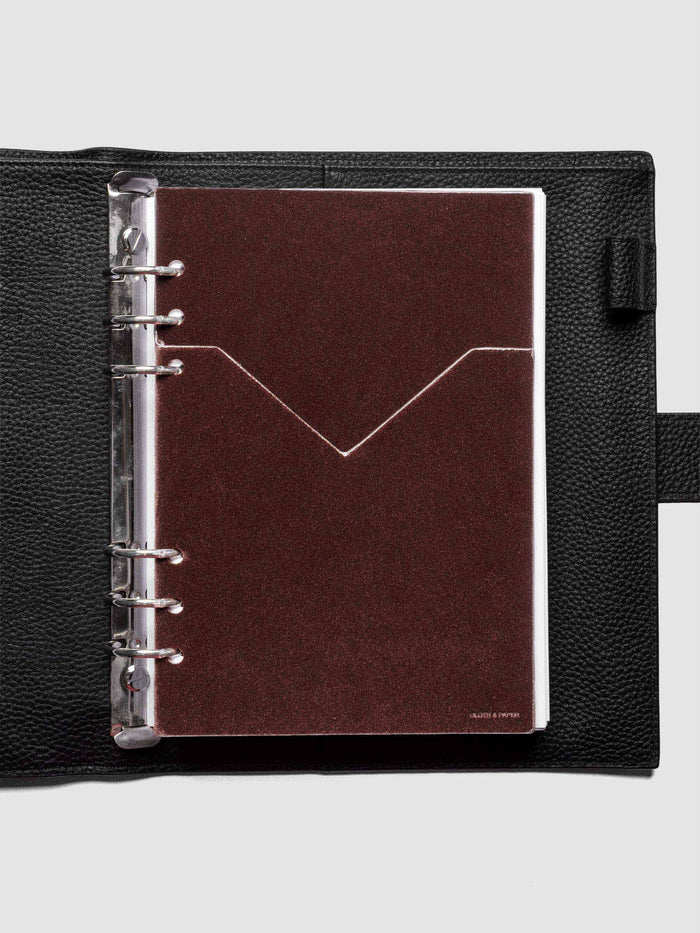 Velvet Pocket Folder in Bordeaux pre-punched for A5 planners shown in a black leather agenda.