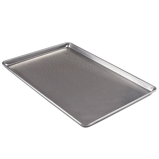 Metal baking tray with perforated surface on a white background.