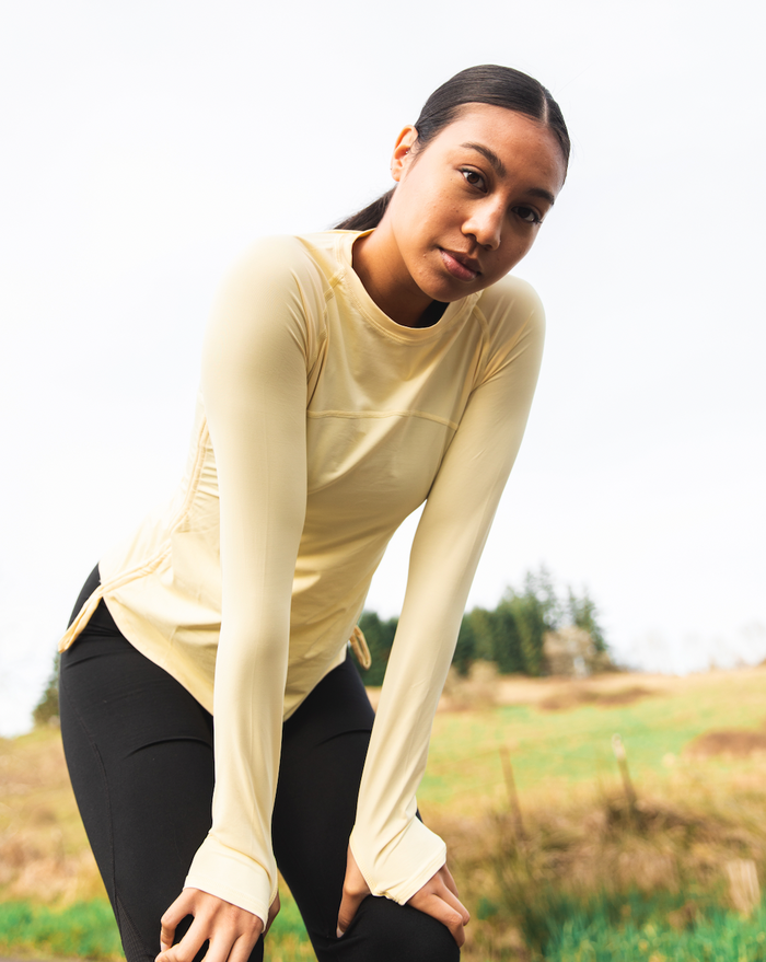 Women standing outside wearing lemon yellow long sleeve drawstring crew with black tights. (Style 2006) - BloqUV