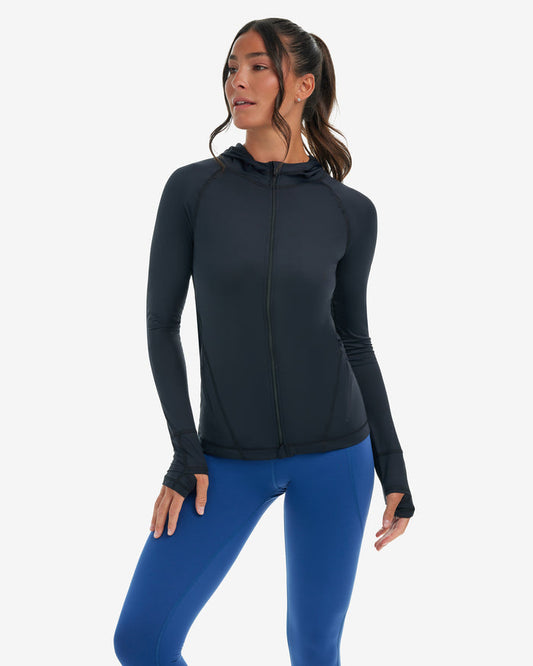 Woman wearing a black hoodie jacket on a white background