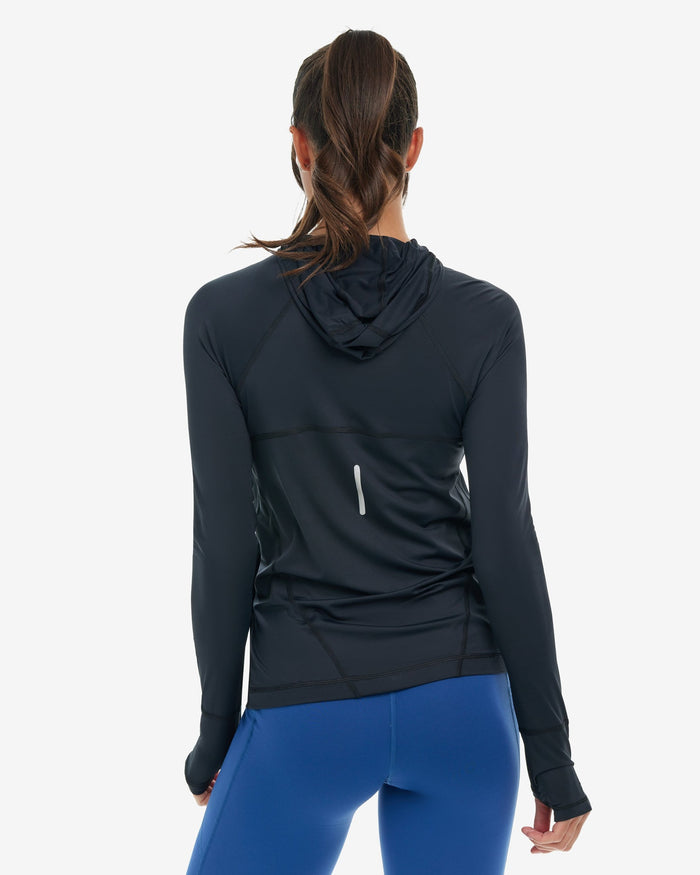 Woman wearing a black hoodie jacket on a white background
