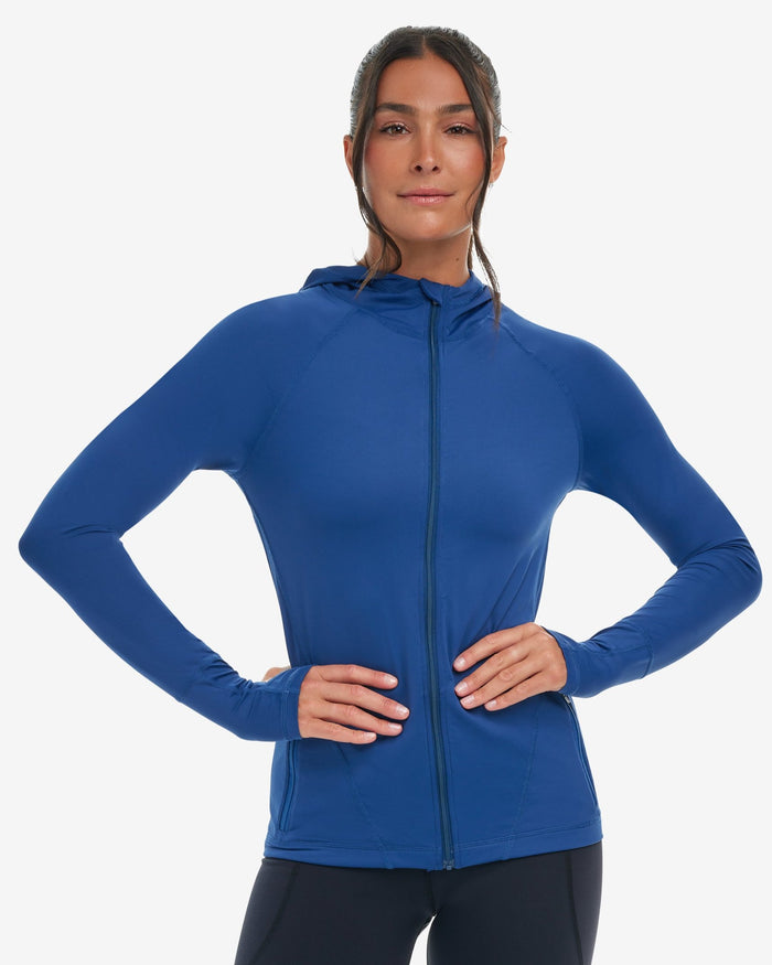 Woman wearing a blue hoodie jacket on a white background
