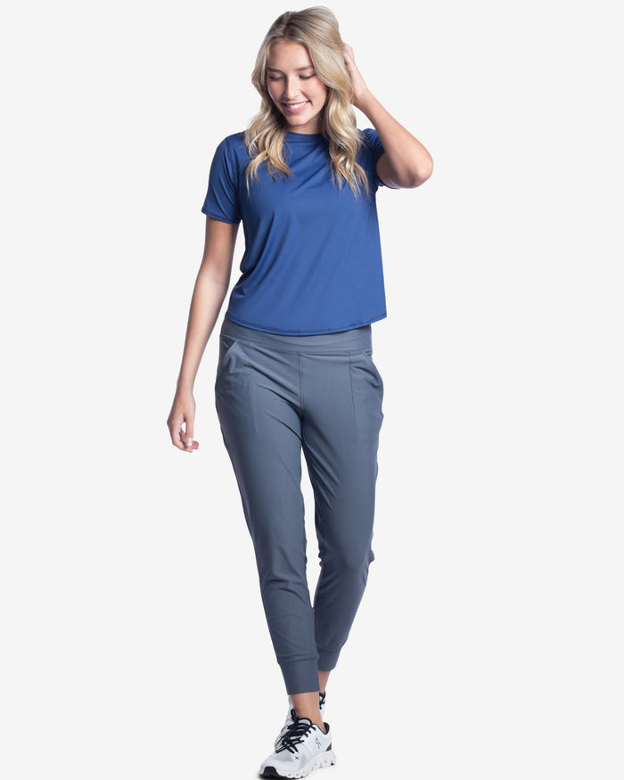 A pair of blue women's joggers with a high waist and front pockets.