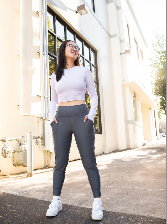 A pair of blue women's joggers with a high waist and front pockets.