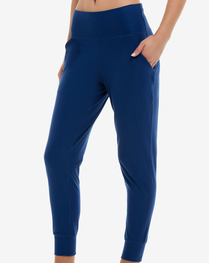 A pair of blue women's joggers with a high waist and front pockets.