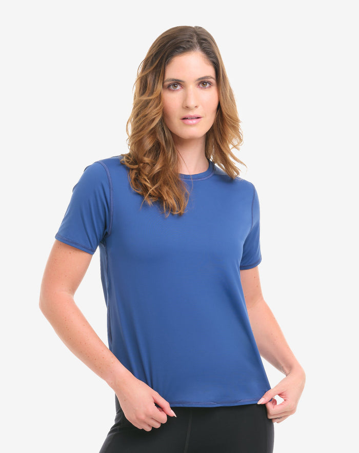Woman wearing a blue t-shirt and black leggings on a white background