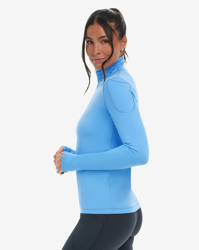 Women wearing indigo turtle neck top with black tights. (Style 2013) - BloqUV