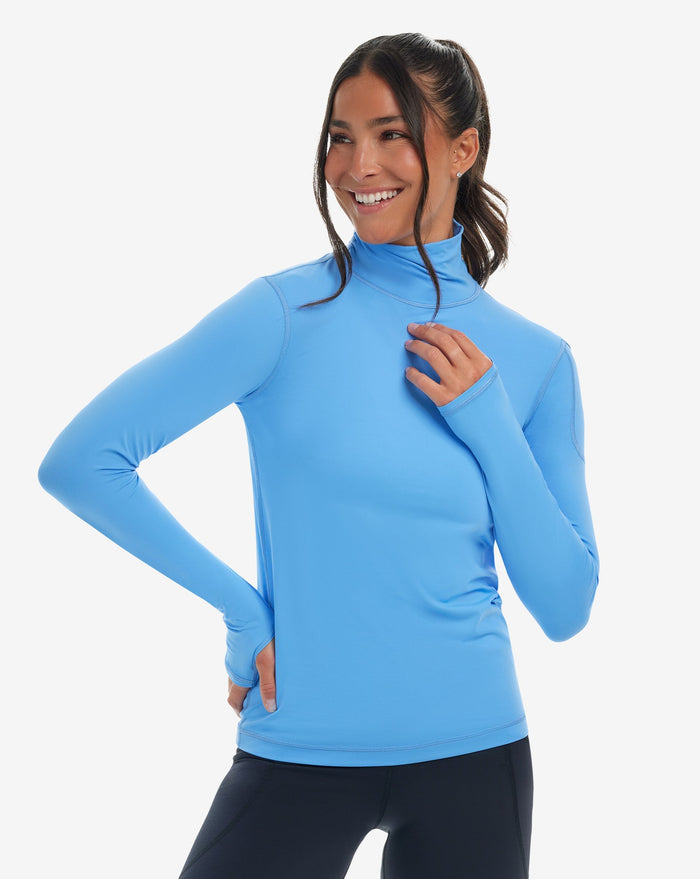 Women wearing indigo turtle neck top with black tights. (Style 2013) - BloqUV